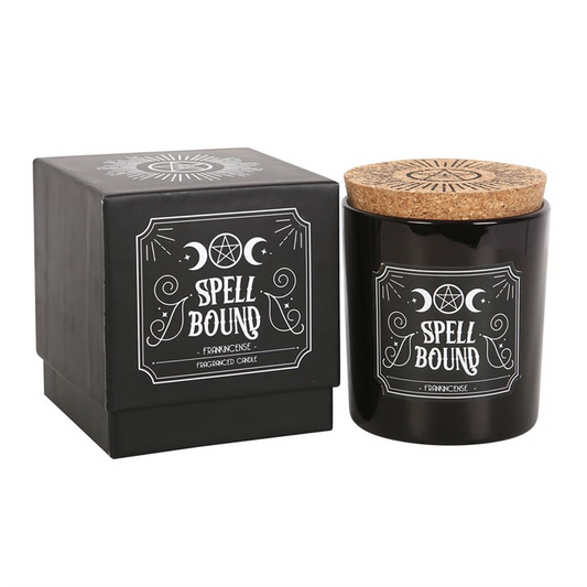 Black candle with cork lid and decorative box labeled 'Spell Bound' on a white background