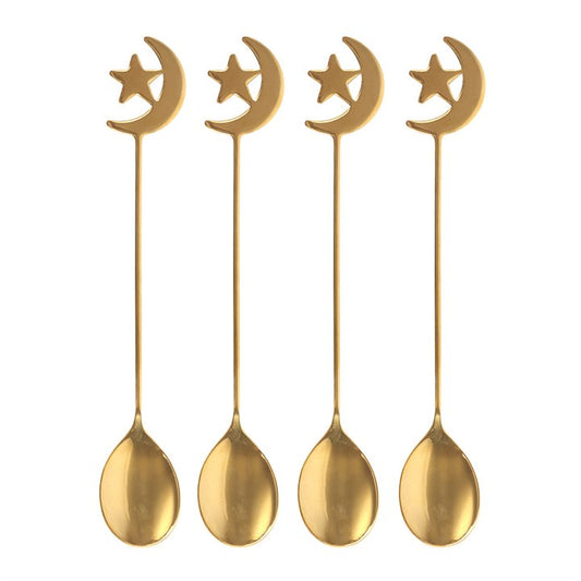 Four gold spoons with moon and star designs on a white background