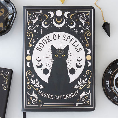 Decorative notebook titled 'Book of Spells: Magick Cat Energy' with a black cat illustration on a white background.