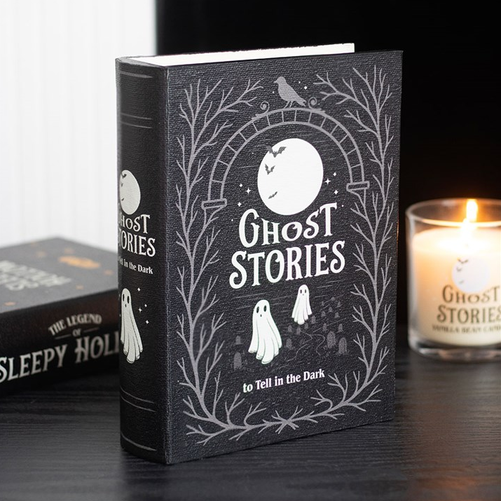 Book titled 'Ghost Stories to Tell in the Dark' with a candle in the background