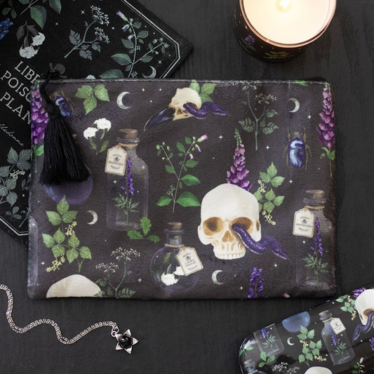 Dark pouch with skull and potion bottle design on a black surface
