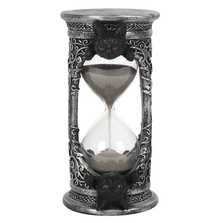 Decorative hourglass with intricate designs on a white background