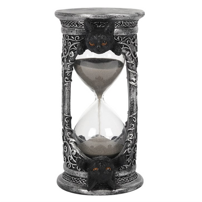 Decorative hourglass with intricate designs on a white background
