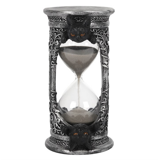 Decorative hourglass with intricate designs on a white background