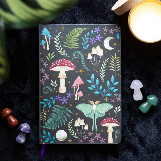 Notebook with colorful mushroom and leaf design on a dark background