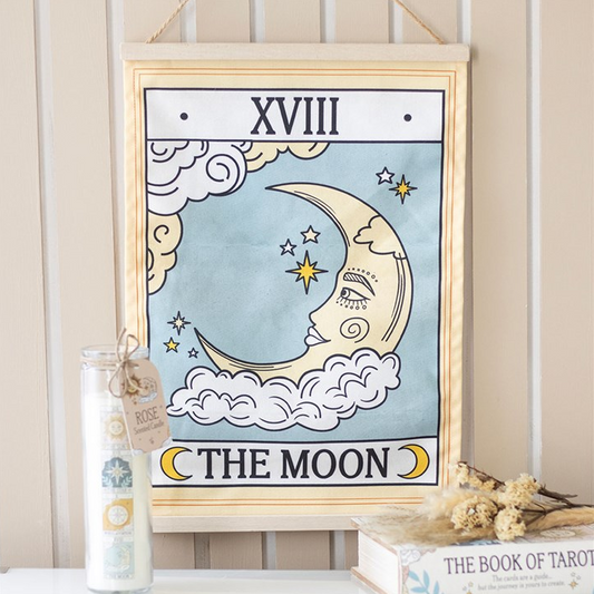 Framed artwork with a moon and star design on a wall.