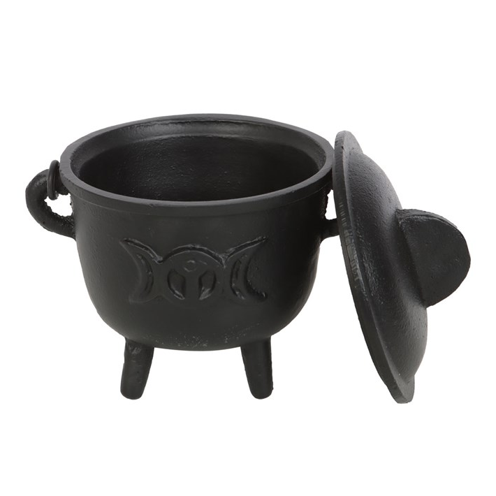 A black cast iron cauldron-shaped container with a matching lid leaning against it, featuring a triple moon symbol embossed on the front, set against a plain white background.