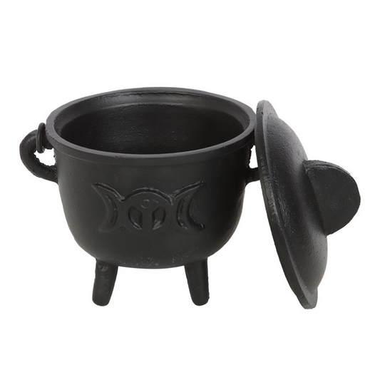 A black cast iron cauldron-shaped container with a matching lid leaning against it, featuring a triple moon symbol embossed on the front, set against a plain white background.