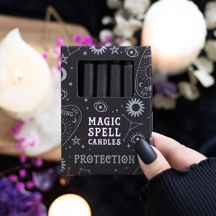 Box of 'Magic Spell Candles Protection' with a hand holding it against a mystical background.