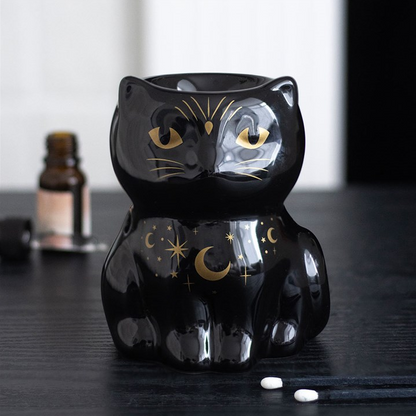 Black cat-shaped night light with star and moon designs on a dark surface.