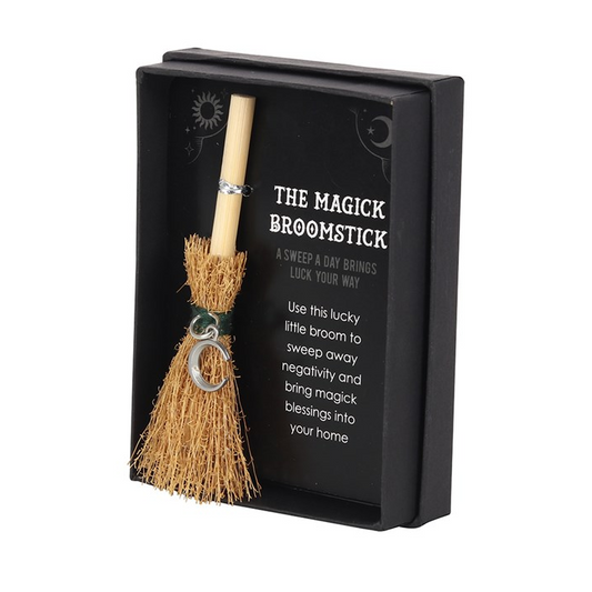 Magical broomstick with a keychain in a black box on a white background