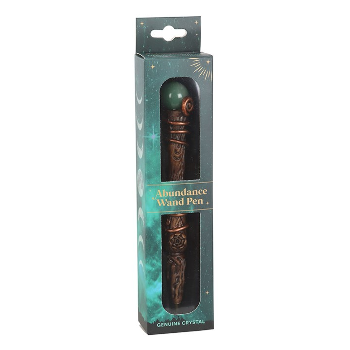 A packaged wand pen with a dark green crystal ball top and an ornate bronze-colored body, shown in its retail box against a plain white background.