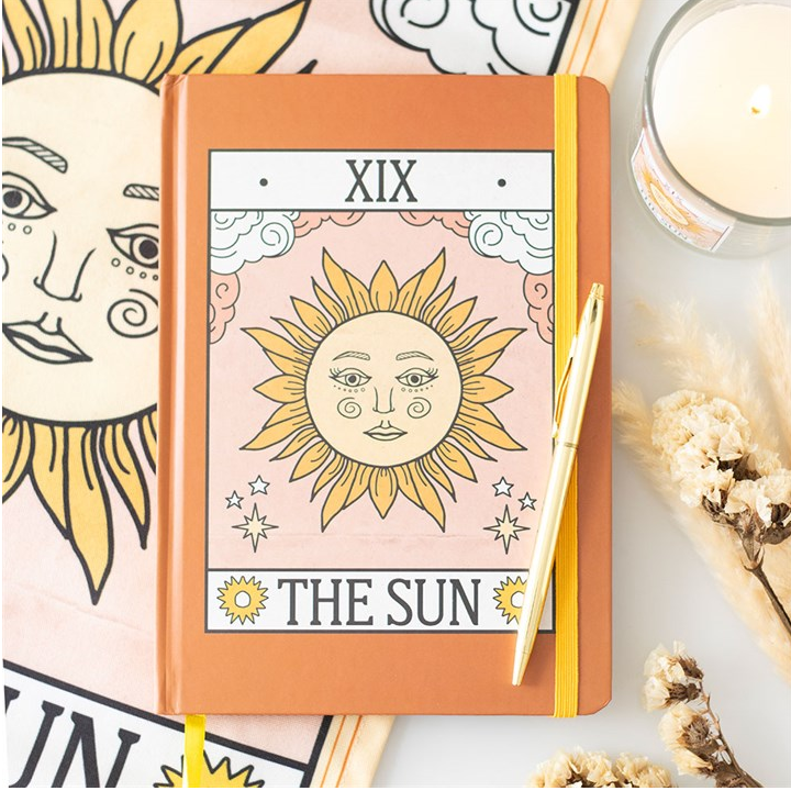 Notebook with 'The Sun' design on a white background