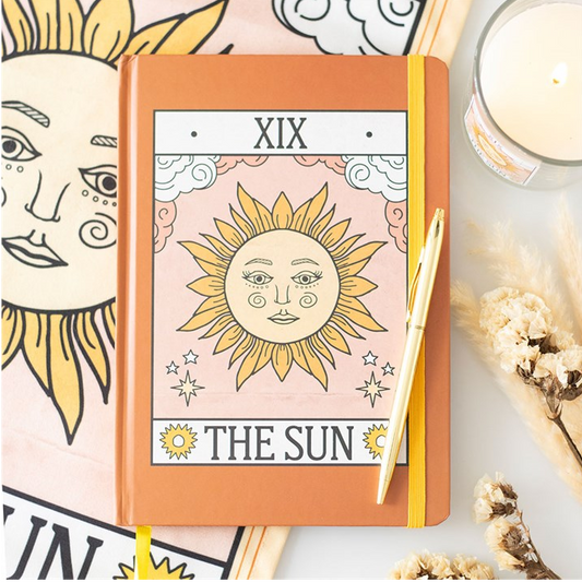 Notebook with 'The Sun' design on a white background