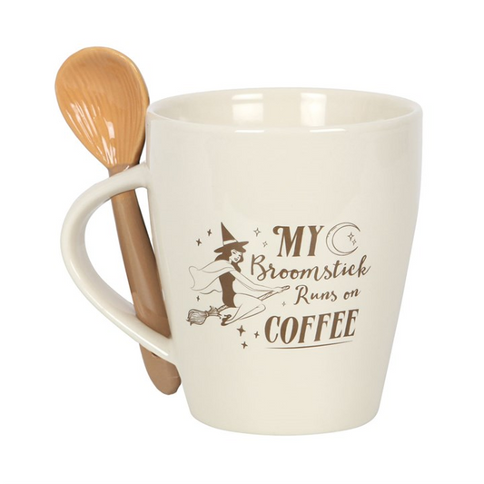 White mug with wooden spoon featuring text 'My Broomstick Runs on Coffee' on a white background