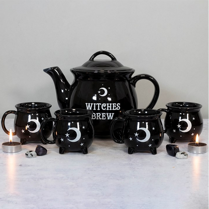 Black ceramic teapot and mugs with 'Witches Brew' text on a light background