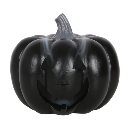 Black pumpkin-shaped container with a face on a white background