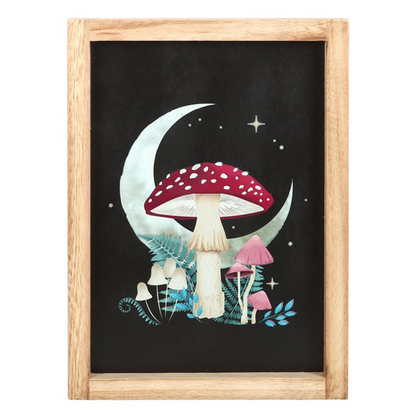 Framed artwork with mushrooms and a moon on a black background