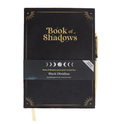 Black notebook titled 'Book of Shadows' with gold text on a white background