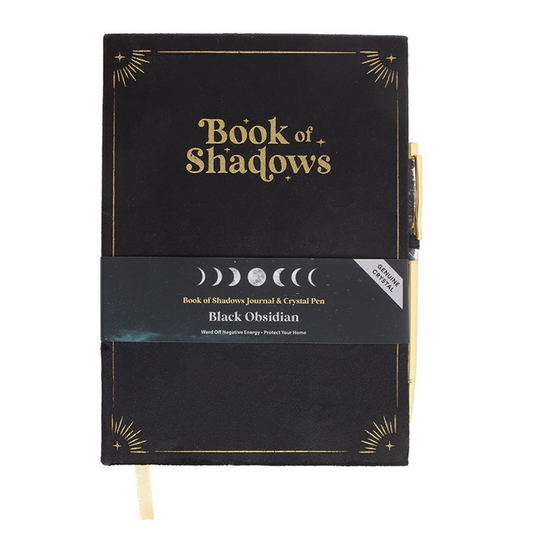 Black notebook titled 'Book of Shadows' with gold text on a white background