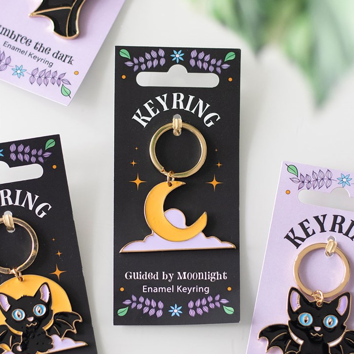 Keyring packaging with black cat and moon design on a white background