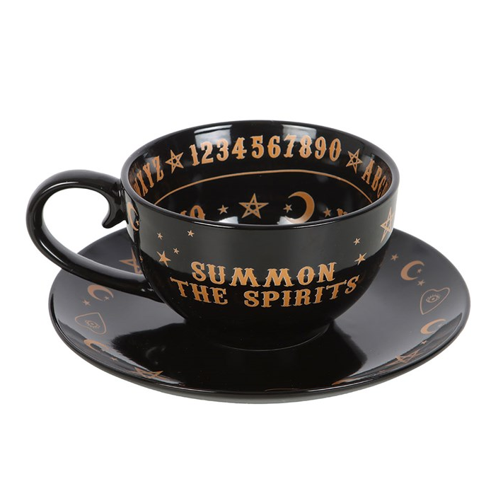 Black cup and saucer set with 'Summon the Spirits' text and star designs on a white background