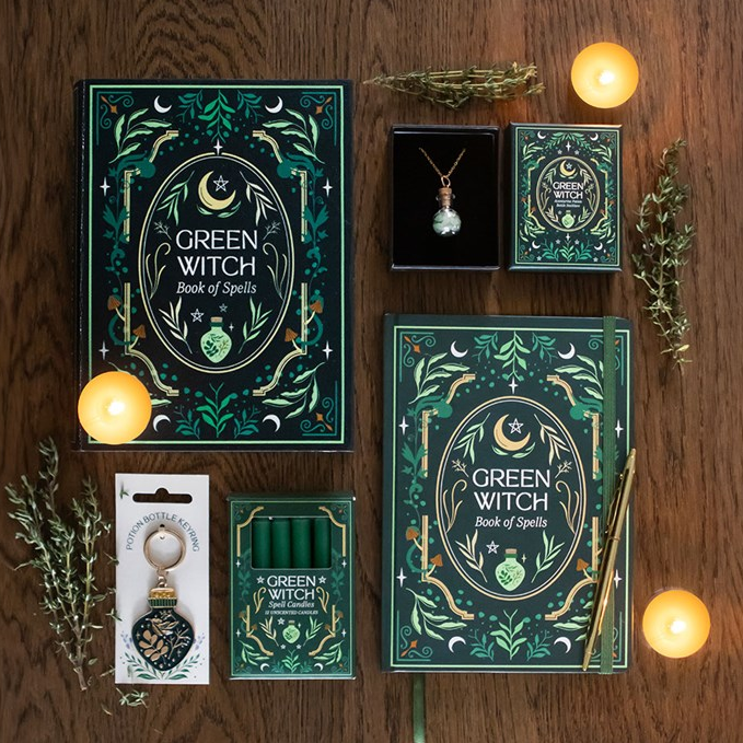 Collection of 'Green Witch' themed products on a wooden surface with candles and herbs.