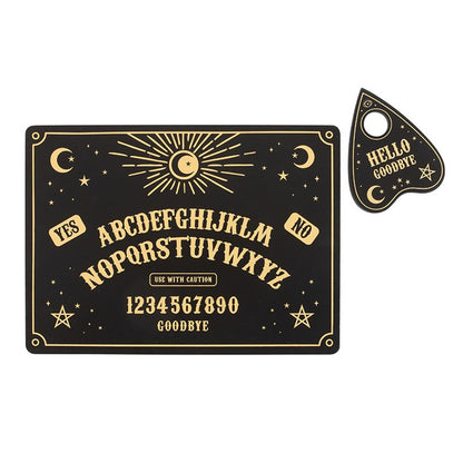 Ouija board with gold text and symbols on a black background, accompanied by a small keychain with 'Hello Goodbye' text.