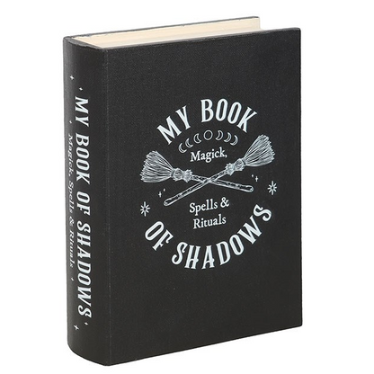 Black book titled 'My Book of Shadows' with white text on a white background