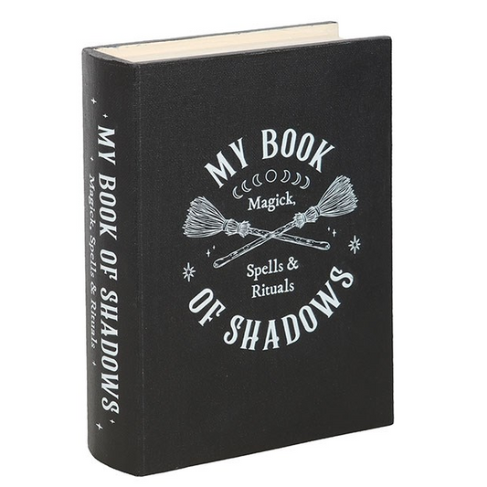 Black book titled 'My Book of Shadows' with white text on a white background