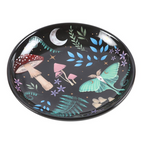 Decorative plate with fairy, mushroom, and butterfly design on a black background