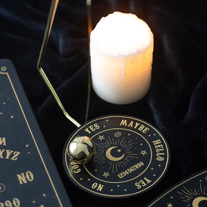Divination tool with a candle and cards on a dark background