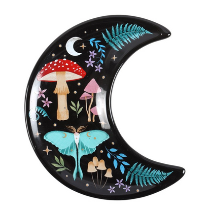 Decorative moon-shaped plate with fairy tale elements on a white background
