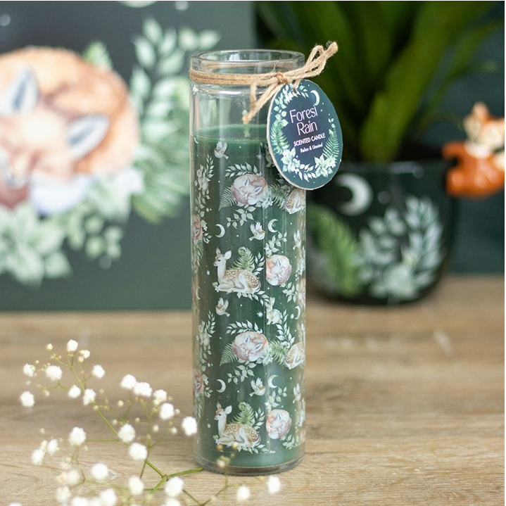 Decorative candle with floral design and label on a wooden surface