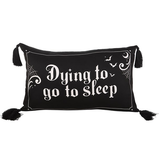 Black pillow with white text 'Dying to go to sleep' on a white background