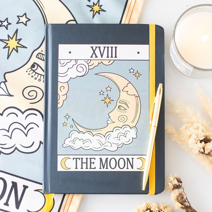 Notebook with celestial design and 'The Moon' label on a decorative background