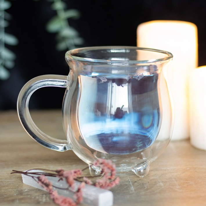 Clear glass mug on a wooden surface with a blurred background