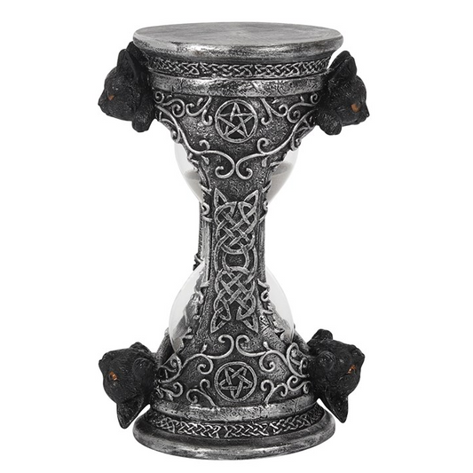 Decorative hourglass with intricate designs on a white background