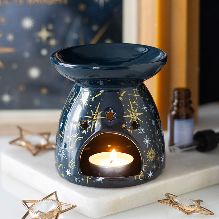 Decorative wax warmer with star pattern on a white surface