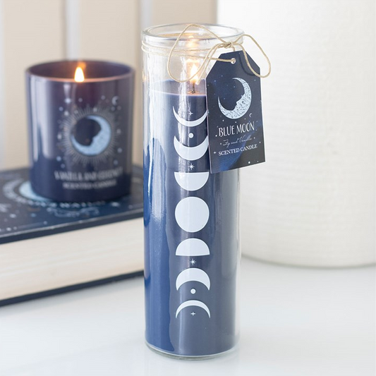 Candle with moon phases design on a white surface