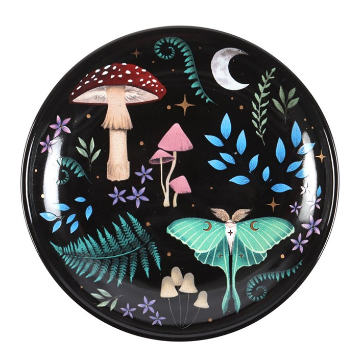 Decorative plate with mushrooms and a butterfly design on a black background