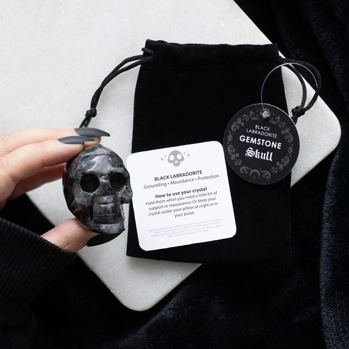 Black Lava Stone with packaging and information card on a white surface